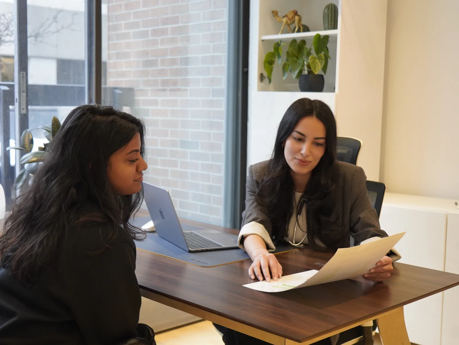 Nurse Practitioner reviewing health documents with a patient at Care&